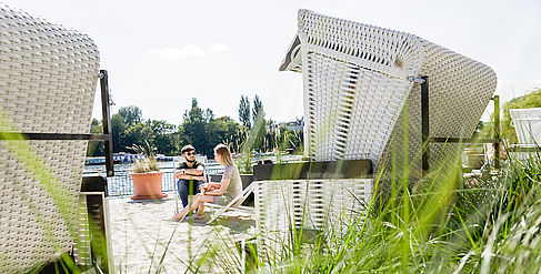Two students in a beach chair on the Wilhelminenhof campus