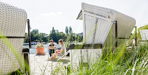 Two students in a beach chair on the Wilhelminenhof campus 